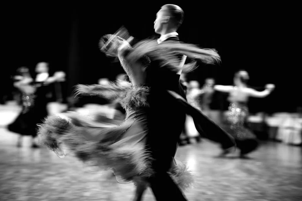 couple dancing on competition floor, black and white